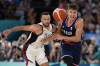 United States' Stephen Curry (4) and Bogdan Bogdanovic (7), of Serbia battle for the ball during a men's semifinals basketball game at Bercy Arena at the 2024 Summer Olympics, Thursday, Aug. 8, 2024, in Paris, France. (AP Photo/Mark J. Terrill)