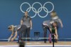 Loaders set the weight on the bar during the women's 59kg weightlifting event at the 2024 Summer Olympics, Thursday, Aug. 8, 2024, in Paris, France. (AP Photo/Kin Cheung)