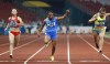 FILE - India's Dutee Chand crosses the finish line in her women's 100m semifinal during the athletics competition at the 18th Asian Games in Jakarta, Indonesia, Sunday, Aug. 26, 2018. (AP Photo/Bernat Armangue, File)