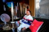 Anderson .Paak laughs as he sits next to the Olympic torch, during an interview with The Associated Press, at the 2024 Summer Olympics, Thursday, Aug. 8, 2024, in Paris, France. (AP Photo/Michel Euler)