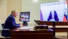 Russian President Vladimir Putin, left, listens to acting Governor of Kursk region Alexei Smirnov during a meeting via videoconference at the Novo-Ogaryovo state residence outside Moscow, Russia, Thursday, Aug. 8, 2024. (Gavriil Grigorov, Sputnik, Kremlin Pool Photo via AP)