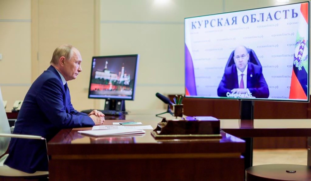 Russian President Vladimir Putin, left, listens to acting Governor of Kursk region Alexei Smirnov during a meeting via videoconference at the Novo-Ogaryovo state residence outside Moscow, Russia, Thursday, Aug. 8, 2024. (Gavriil Grigorov, Sputnik, Kremlin Pool Photo via AP)