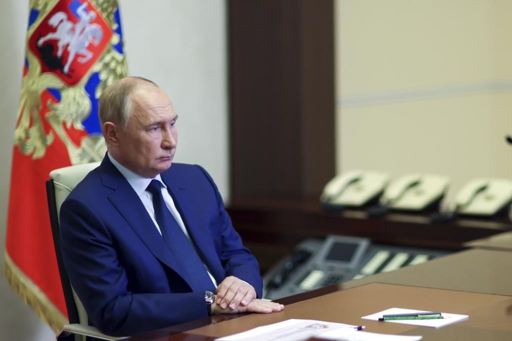 Russian President Vladimir Putin listens to acting Governor of Kursk region Alexei Smirnov during a meeting via videoconference at the Novo-Ogaryovo state residence outside Moscow, Russia, Thursday, Aug. 8, 2024. (Gavriil Grigorov, Sputnik, Kremlin Pool Photo via AP)