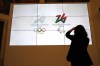 FILE - The logos of 2026 Milan-Cortina Olympics and Paralympics, right, are unveiled to the journalists at a press conference in Rome, Tuesday, March 30, 2021. (AP Photo/Alessandra Tarantino, File)