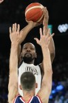 United States' LeBron James (6) goes up for a shot over Ognjen Dobric (13), of Serbia during a men's semifinals basketball game at Bercy Arena at the 2024 Summer Olympics, Thursday, Aug. 8, 2024, in Paris, France. (AP Photo/Mark J. Terrill)