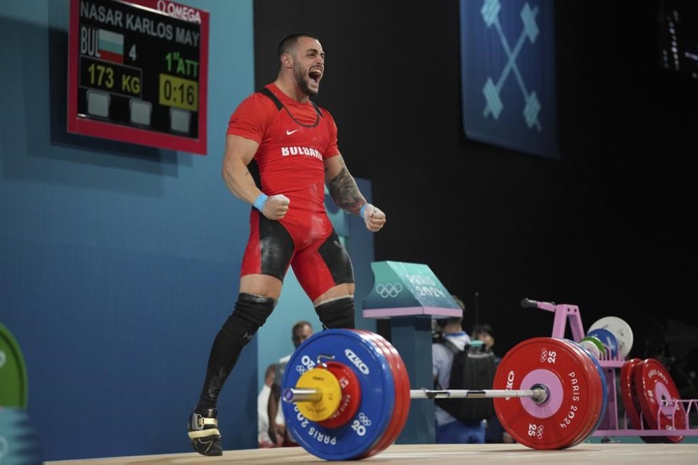 Karlos May Nasar of Bulgaria reacts during the men's 89kg weightlifting event, at the 2024 Summer Olympics, Friday, Aug. 9, 2024, in Paris, France. (AP Photo/Kin Cheung)