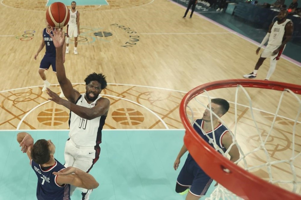 United States' Joel Embiid (11) shoots during a men's semifinal basketball game against Serbia at Bercy Arena at the 2024 Summer Olympics, Thursday, Aug. 8, 2024, in Paris, France. (Gregory Shamus/Pool Photo via AP)
