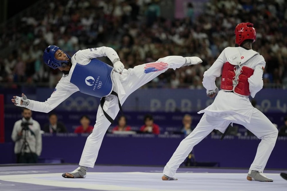 United States' Cj Nickolas competes with Burkina Faso's Faysal Sawadogo in a men's 80kg Taekwondo quarterfinal match during the 2024 Summer Olympics, at the Grand Palais, Friday, Aug. 9, 2024, in Paris, France. (AP Photo/Andrew Medichini)