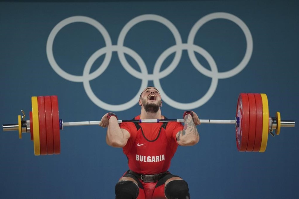 Karlos May Nasar of Bulgaria competes during the men's 89kg weightlifting event, at the 2024 Summer Olympics, Friday, Aug. 9, 2024, in Paris, France. (AP Photo/Kin Cheung)