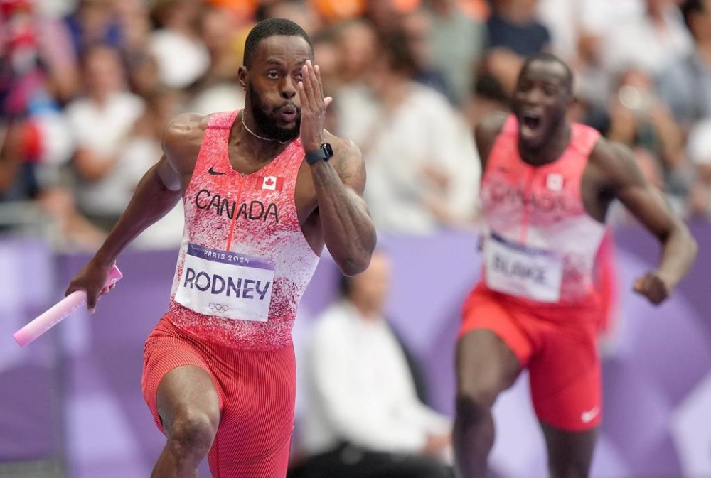 Canada's Jerome Blake cheers as teammate Brendon Rodney runs the baton in the men's 4 x 100m relay during the Paris Summer Olympics in Saint-Denis, France, Friday, Aug. 9, 2024. THE CANADIAN PRESS/Nathan Denette