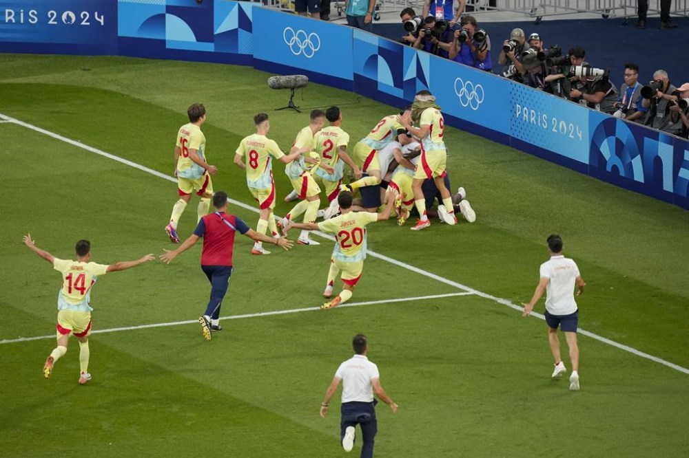 Spain's players celebrate at the end of the men's soccer gold medal match between France and Spain at the Parc des Princes during the 2024 Summer Olympics, Friday, Aug. 9, 2024, in Paris, France. (AP Photo/Vadim Ghirda)