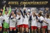 FILE - Washington Spirit's Andi Sullivan, center, lifts the trophy as they celebrate after defeating the Chicago Red Stars in the NWSL Championship soccer match, Saturday, Nov. 20, 2021, in Louisville, Ky. (AP Photo/Jeff Dean, File)