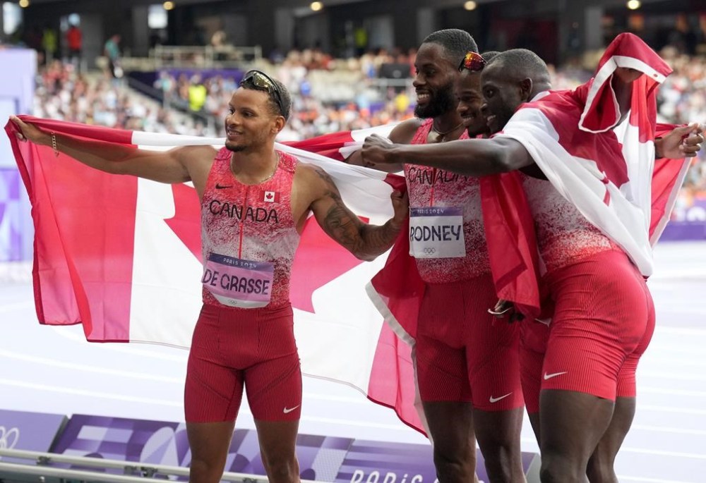 Canada's men's 4 x 100m relay team, from left to right, Andre De Grasse, Brendon Rodney, Aaron Brown and Jerome Blake celebrate their gold medal finish during the Paris Summer Olympics in Saint-Denis, France, Friday, Aug. 9, 2024. THE CANADIAN PRESS/Nathan Denette