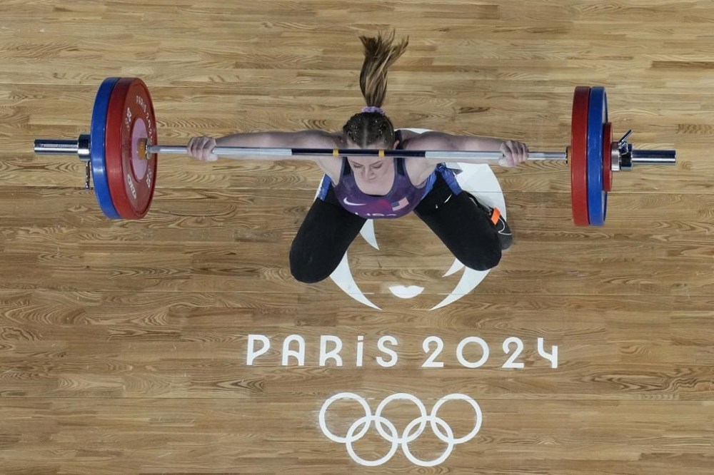 Olivia Reeves of the United States competes during the women's 71kg weightlifting event, at the 2024 Summer Olympics, Friday, Aug. 9, 2024, in Paris, France. (AP Photo/Dita Alangkara,Pool)