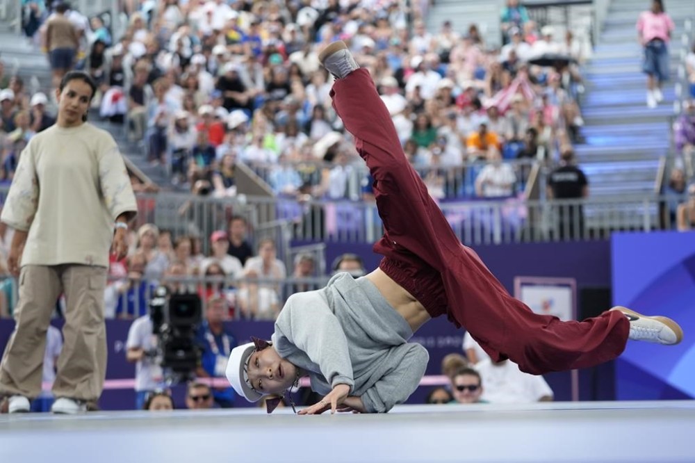 Japan's Ami Yuasa, known as B-Girl Ami, right, competes during the Round Robin Battle at the breaking competition at La Concorde Urban Park at the 2024 Summer Olympics, Friday, Aug. 9, 2024, in Paris, France. (AP Photo/Frank Franklin)
