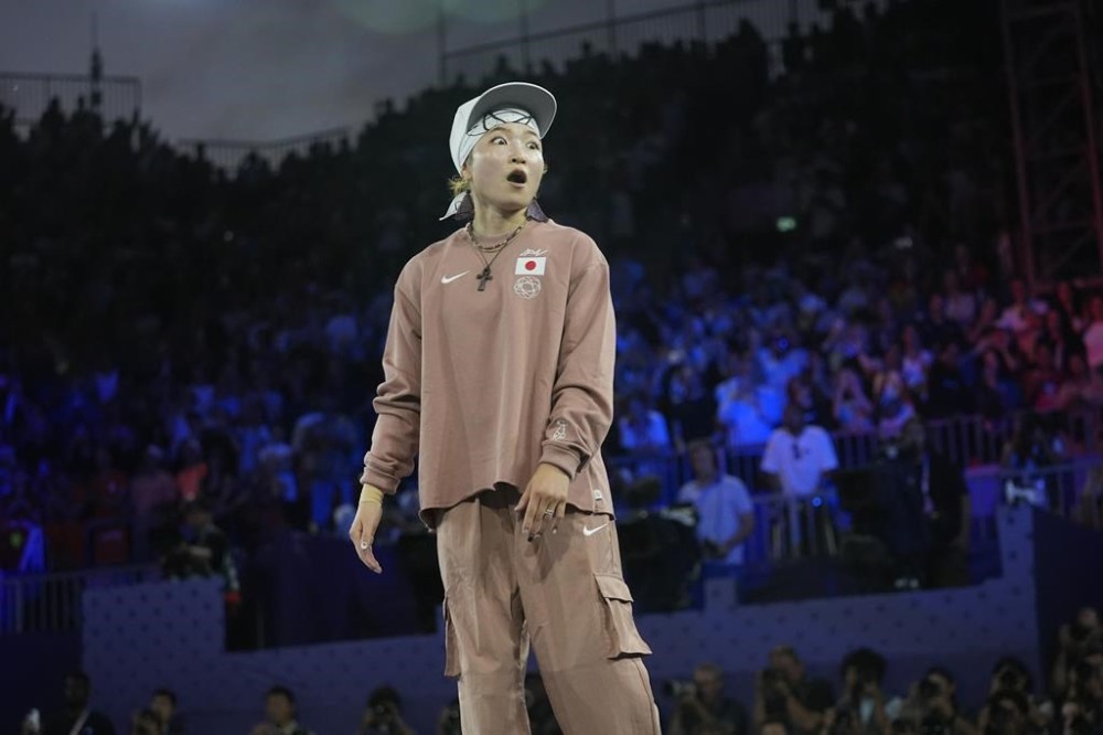 Japan's Ami Yuasa, known as B-Girl Ami, reacts after winning gold during the B-Girls gold medal battle at the breaking competition at La Concorde Urban Park at the 2024 Summer Olympics, Friday, Aug. 9, 2024, in Paris, France. (AP Photo/Frank Franklin)