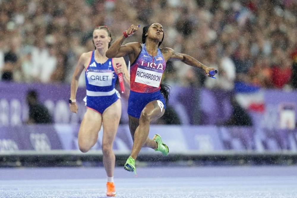 Sha'carri Richardson, of the United States, crosses the finish line to win the women's 4 x 100 meters relay final at the 2024 Summer Olympics, Friday, Aug. 9, 2024, in Saint-Denis, France. (AP Photo/Ashley Landis)