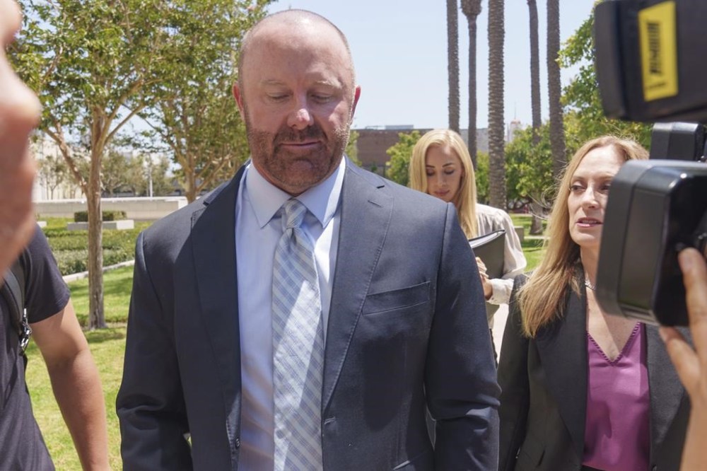 Mathew Bowyer, left, a Southern California bookmaker, arrives with his attorney, Diane Bass, right, at federal court in Santa Ana, Calif., Friday, Aug. 9, 2024. (AP Photo/Damian Dovarganes)