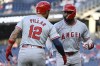 Los Angeles Angels' Jo Adell, right, is greeted by teammate Kevin Pillar at home plate on a two-run home run in which he also drove in Pillar during the second inning of a baseball game against the Washington Nationals, Friday, Aug. 9, 2024, in Washington. (AP Photo/John McDonnell)