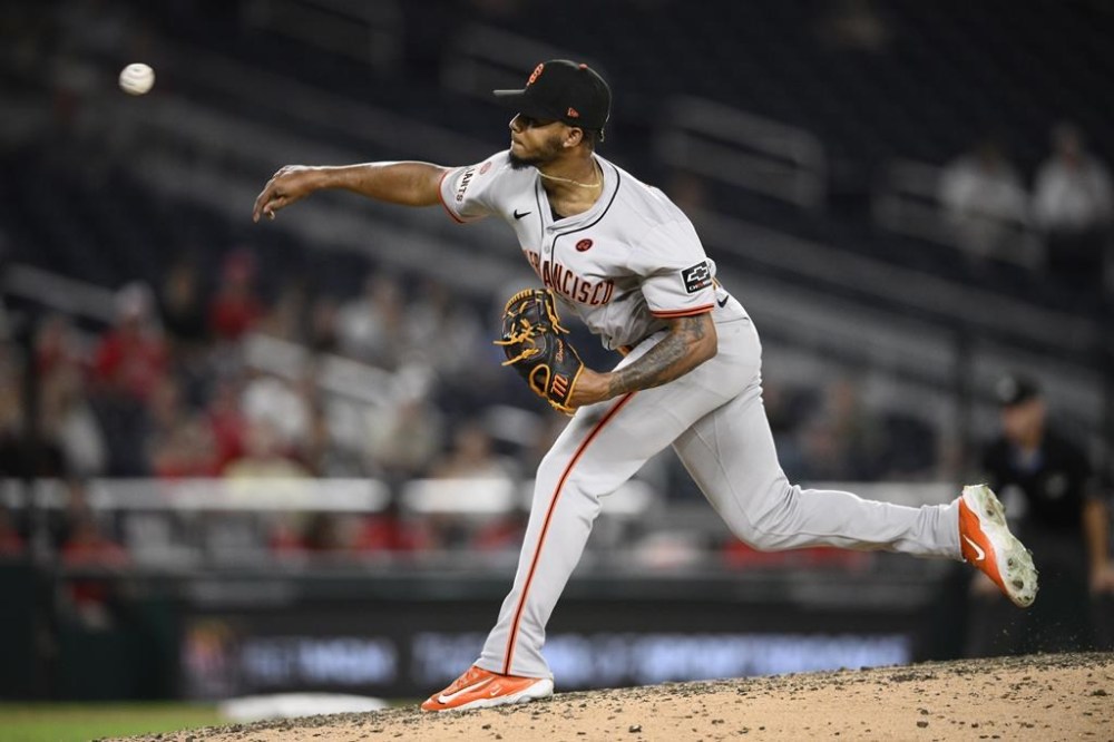 San Francisco Giants relief pitcher Camilo Doval throws during the ninth inning of a baseball game against the Washington Nationals, Wednesday, Aug. 7, 2024, in Washington. (AP Photo/Nick Wass)