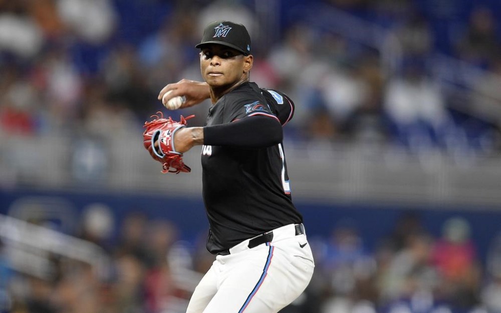 Miami Marlins pitcher Edward Cabrera throws to first base during the second inning of a baseball game against the San Diego Padres, Friday, Aug. 9, 2024, in Miami. (AP Photo/Michael Laughlin)