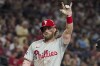 Philadelphia Phillies' Bryce Harper celebrates after hitting a solo home run against the Arizona Diamondbacks during the seventh inning of a baseball game Friday, Aug. 9, 2024, in Phoenix. (AP Photo/Darryl Webb)