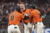 San Francisco Giants' Mark Canha, middle, is congratulated by teammates after hitting a sacrifice fly that scored Michael Conforto (8) for the winning run during the ninth inning of a baseball game against the Detroit Tigers in San Francisco, Friday, Aug. 9, 2024. (AP Photo/Jeff Chiu)