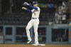 Los Angeles Dodgers' Freddie Freeman celebrates while standing on second base after hitting a double against the Pittsburgh Pirates during the third inning of a baseball game Friday, Aug. 9, 2024, in Los Angeles. (AP Photo/John McCoy)