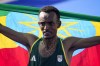 Ethiopia's Tamirat Tola celebrates after crossing the finish line to win the gold medal at the end of the men's marathon competition at the 2024 Summer Olympics, Saturday, Aug. 10, 2024, in Paris, France. (AP Photo/Vadim Ghirda)