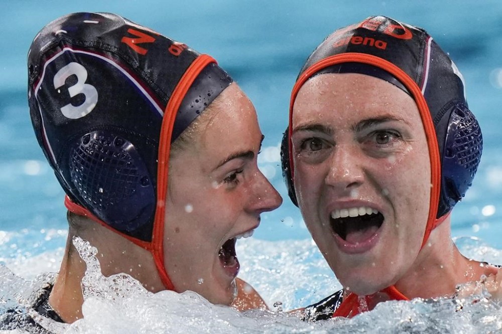 Netherland's Sabrina Van Der Sloot, right, celebrates with teammate Brigitte Sleeking after scoring against United States during the women's bronze medal water polo match at the 2024 Summer Olympics, Saturday, Aug. 10, 2024, in Paris, France. (AP Photo/Luca Bruno)