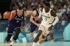 Aleksa Avramovic (30), of Serbia drives down the court under pressure from Dennis Schroder (17), of Germany during a men's bronze medal basketball game at Bercy Arena at the 2024 Summer Olympics, Saturday, Aug. 10, 2024, in Paris, France. (AP Photo/Mark J. Terrill)