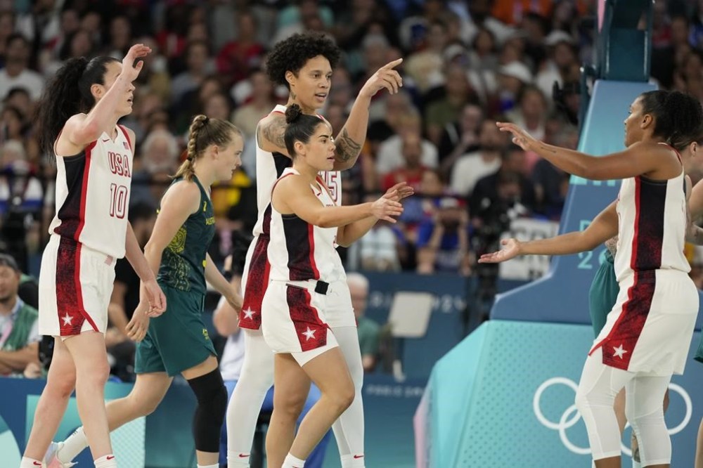 Team USA celebrate a basket against Australia during a women's semifinal basketball game at Bercy Arena at the 2024 Summer Olympics, Friday, Aug. 9, 2024, in Paris, France. (AP Photo/Michael Conroy)