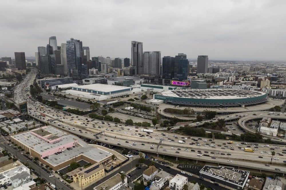 FILE - This aerial view shows traffic moving along the 110 Freeway past the Los Angeles Convention Center in Los Angeles, Tuesday, Sept. 5, 2023. As the Olympics close in Paris, Los Angeles will take the torch. The city will become the third city to host the games three times as it adds 2028 to the locally legendary years of 1932 and 1984. (AP Photo/Jae C. Hong, File)