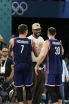 Bogdan Bogdanovic (7), of Serbia and Aleksa Avramovic (30), of Serbia greet Carmelo Anthony after Serbia beat Germany during a men's bronze medal basketball game at Bercy Arena at the 2024 Summer Olympics, Saturday, Aug. 10, 2024, in Paris, France. (AP Photo/Mark J. Terrill)