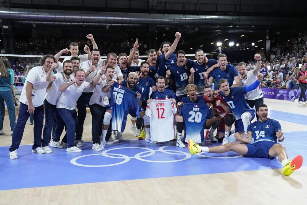 The French team pose for a photo after winning a gold medal men's volleyball match against Poland at the 2024 Summer Olympics, Saturday, Aug. 10, 2024, in Paris, France. (AP Photo/Dolores Ochoa)
