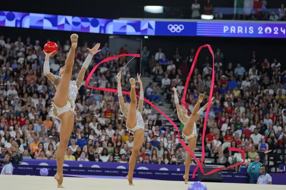 Team Italy performs with ribbons and balls in the group all-around rhythmic gymnastics final at La Chapelle Arena during the 2024 Summer Olympics, Saturday, Aug. 10, 2024, in Paris, France. (AP Photo/Dar Yasin)