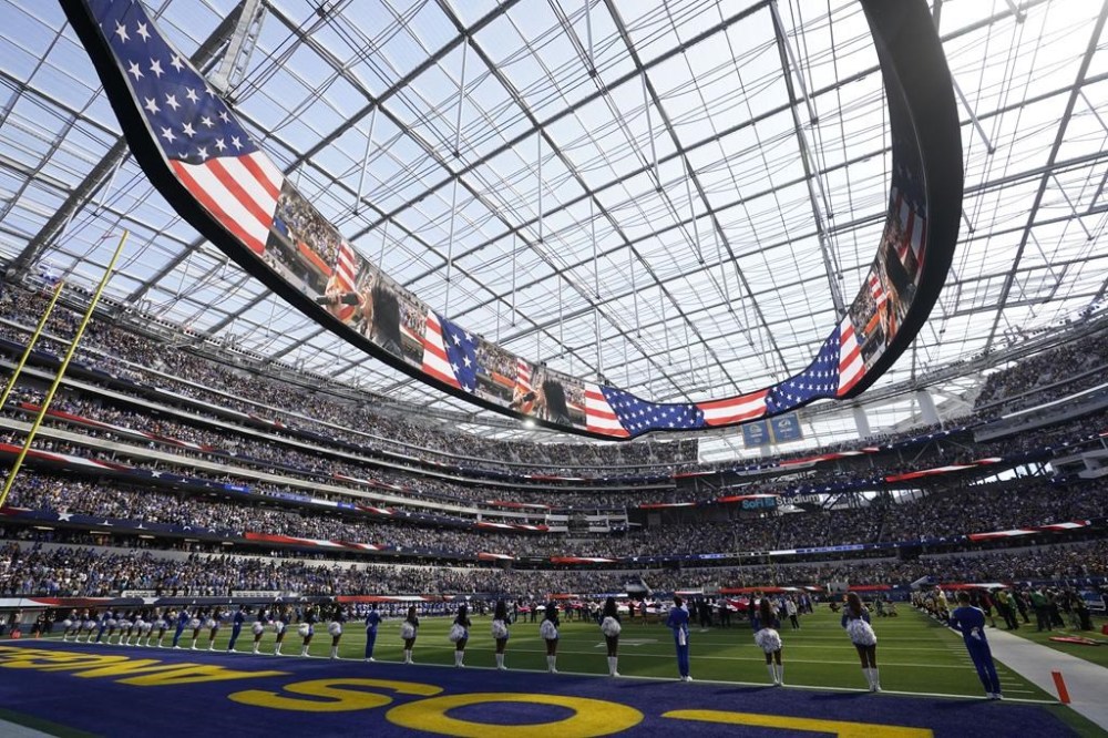 FILE - National anthem wide angle cheerleaders Los Angeles Rams SoFi Stadium of an NFL football game against the Pittsburgh Steelers, Sunday, Oct. 22, 2023, in Inglewood, Calif. As the Olympics close in Paris, Los Angeles will take the torch. The city will become the third city to host the games three times as it adds 2028 to the locally legendary years of 1932 and 1984.(AP Photo/Gregory Bull, File)