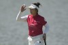 Miyu Yamashita, of Japan, acknowledges the crowd after a birdie putt on the 2nd green during the final round of the women's golf event at the 2024 Summer Olympics, Saturday, Aug. 10, 2024, at Le Golf National, in Saint-Quentin-en-Yvelines, France. (AP Photo/Matt York)