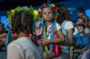 A girl with a traditional flower crown listens to a public talk at the Ukrainian House in Paris, France, Sunday, Aug. 4, 2024. (AP Photo/Hanna Arhirova)