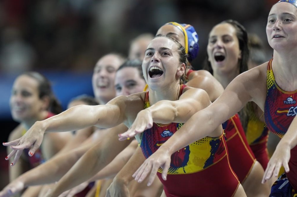 Spain's players celebrates after wining the women's gold medal water polo match against Australia at the 2024 Summer Olympics, Saturday, Aug. 10, 2024, in Paris, France. (AP Photo/Luca Bruno)
