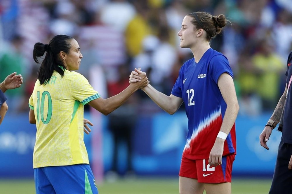 Brazil's Marta, left, greets Tierna Davidson of the United States the women's soccer gold medal match between Brazil and the United States at the Parc des Princes during the 2024 Summer Olympics, Saturday, Aug. 10, 2024, in Paris, France. (AP Photo/Aurelien Morissard)