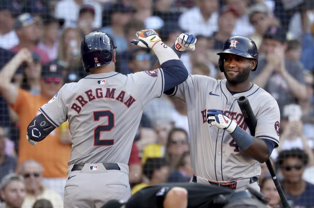 Houston Astros hitter Alex Bregman, left, celebrates after his home run with teammate Yordan Alvarez, right, in the seventh inning of a baseball game against the Boston Red Sox, Saturday, Aug. 10, 2024, in Boston. (AP Photo/Mark Stockwell)