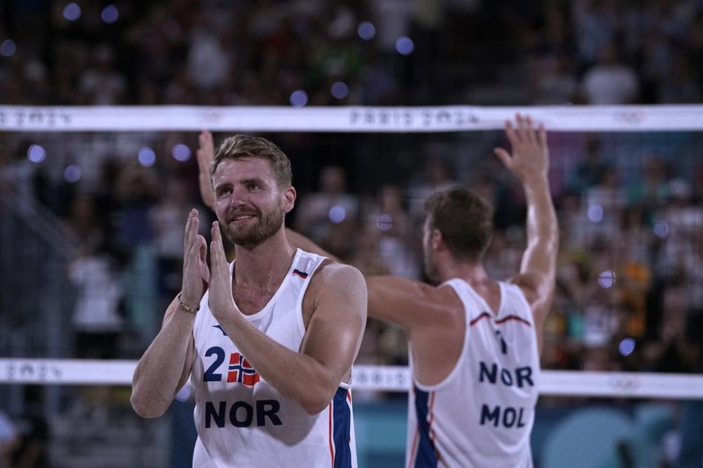 Norway's Anders Berntsen Mol, right, and Norway's Christian Sandlie Sorum celebrate after beating Qatar to win the beach volleyball men's bronze medal match at the 2024 Summer Olympics, Saturday, Aug. 10, 2024, in Paris, France. (AP Photo/Louise Delmotte)