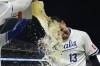 Kansas City Royals' Salvador Perez is doused after his team defeated the St. Louis Cardinals in a baseball game, Saturday, Aug. 10, 2024, in Kansas City, Mo. (AP Photo/Reed Hoffmann)