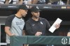 Chicago White Sox interim manager Grady Sizemore, left, listens to pitching coach Tommy Hottovy in the dugout during the fourth inning of a baseball game against the Chicago Cubs on Saturday, August 10, 2024, in Chicago. (AP Photo/Charles Rex Arbogast)