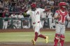 Arizona Diamondbacks' Geraldo Perdomo, left, scores behind Philadelphia Phillies catcher Garrett Stubbs, righht, during the second inning of a baseball game Saturday, Aug 10, 2024, in Phoenix. (AP Photo/Darryl Webb)