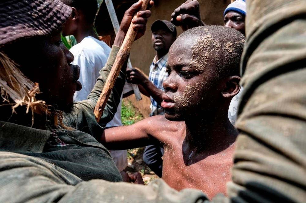 Daniel Wabuyi reacts during his traditional circumcision ritual, known as Imbalu, at Kamu village in Mbale, Eastern Uganda, Saturday, Aug. 3, 2024. (AP Photo/Hajarah Nalwadda)