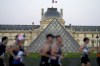 Runners pass the Louvre Museum as they participate in the Pour Tous marathon, at the 2024 Summer Olympics, in Paris, Saturday, Aug. 10, 2024. (AP Photo/Natacha Pisarenko)