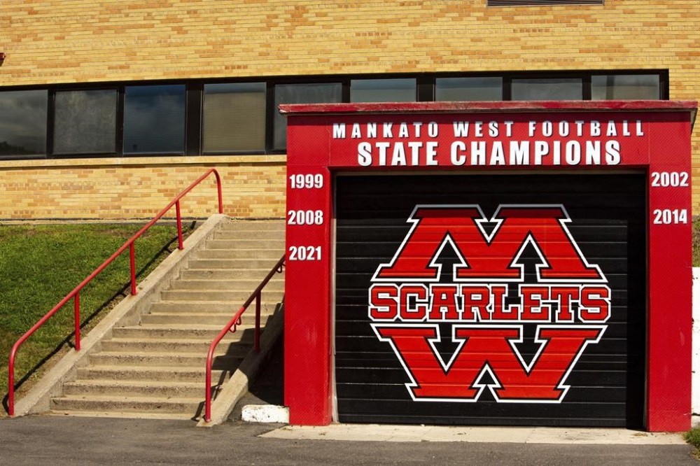 Mankato West High School's football state championship wins are painted on a storage room near the football field, beginning with the 1999 win while Minnesota Gov. Tim Walz was on the coaching staff in Mankato, Minn., Thursday, Aug. 8, 2024. (AP Photo/Nicole Neri)