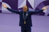 Women's long jump gold medalist Tara Davis-Woodhall, of the United States, celebrates on the podium at the 2024 Summer Olympics, Friday, Aug. 9, 2024, in Saint-Denis, France. (AP Photo/Bernat Armangue)